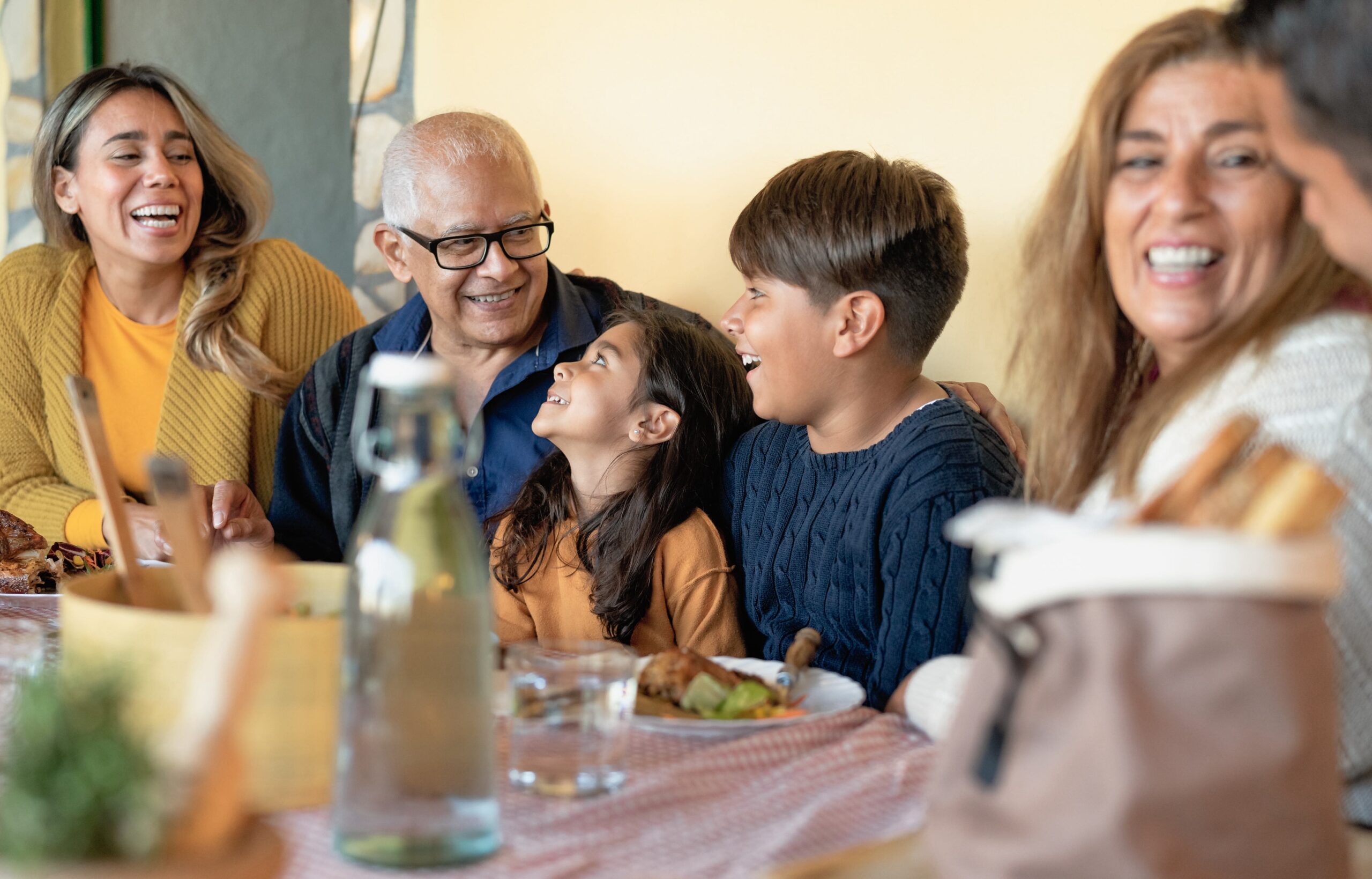 Happy Latin family having fun lunching together at home